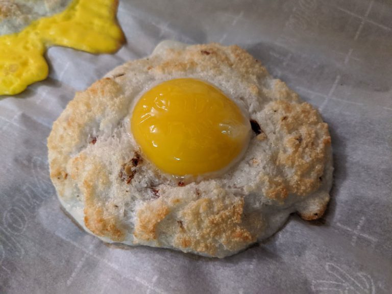 A single chilli coconut egg cloud on parchment paper