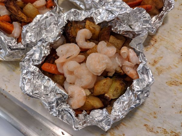 Shrimp and vegetables wrapped in foil.