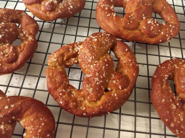 Several pretzels cooling on a wire rack
