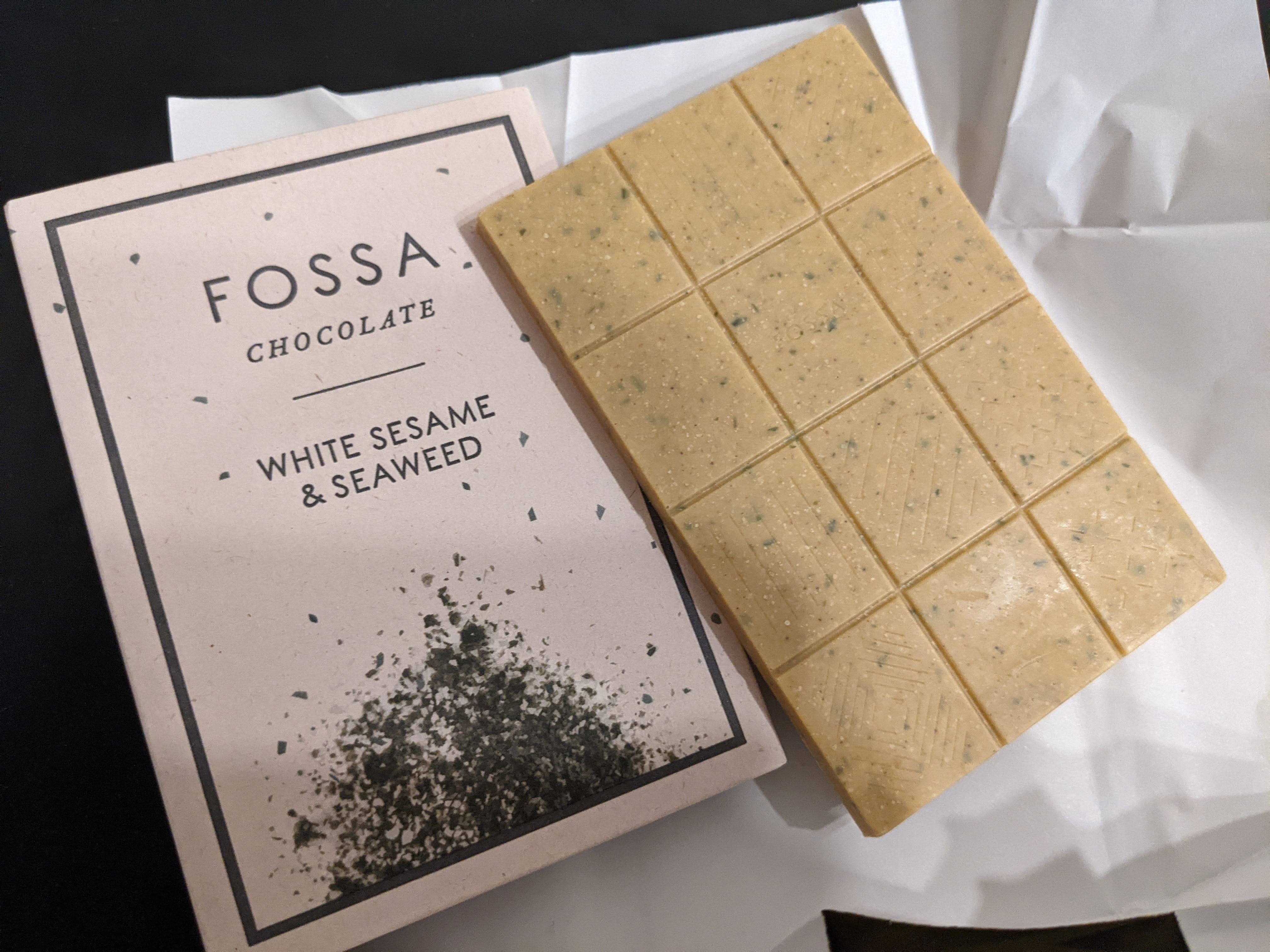 Bar of Fossa white sesame and seaweed chocolate next to packaging.